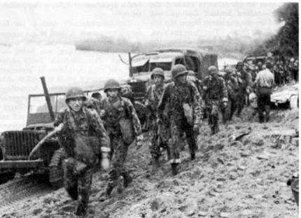Engineers of the 1881st Aviation Battalion with full jungle equipment move along a Hollandia beach in Papua New Guinea in 1944. This photo and information accompanying it are reprinted from the 1987 book The Corps of Engineers: The War Against Japan by Karl C. Dod, which can be read at history.army.mil. T